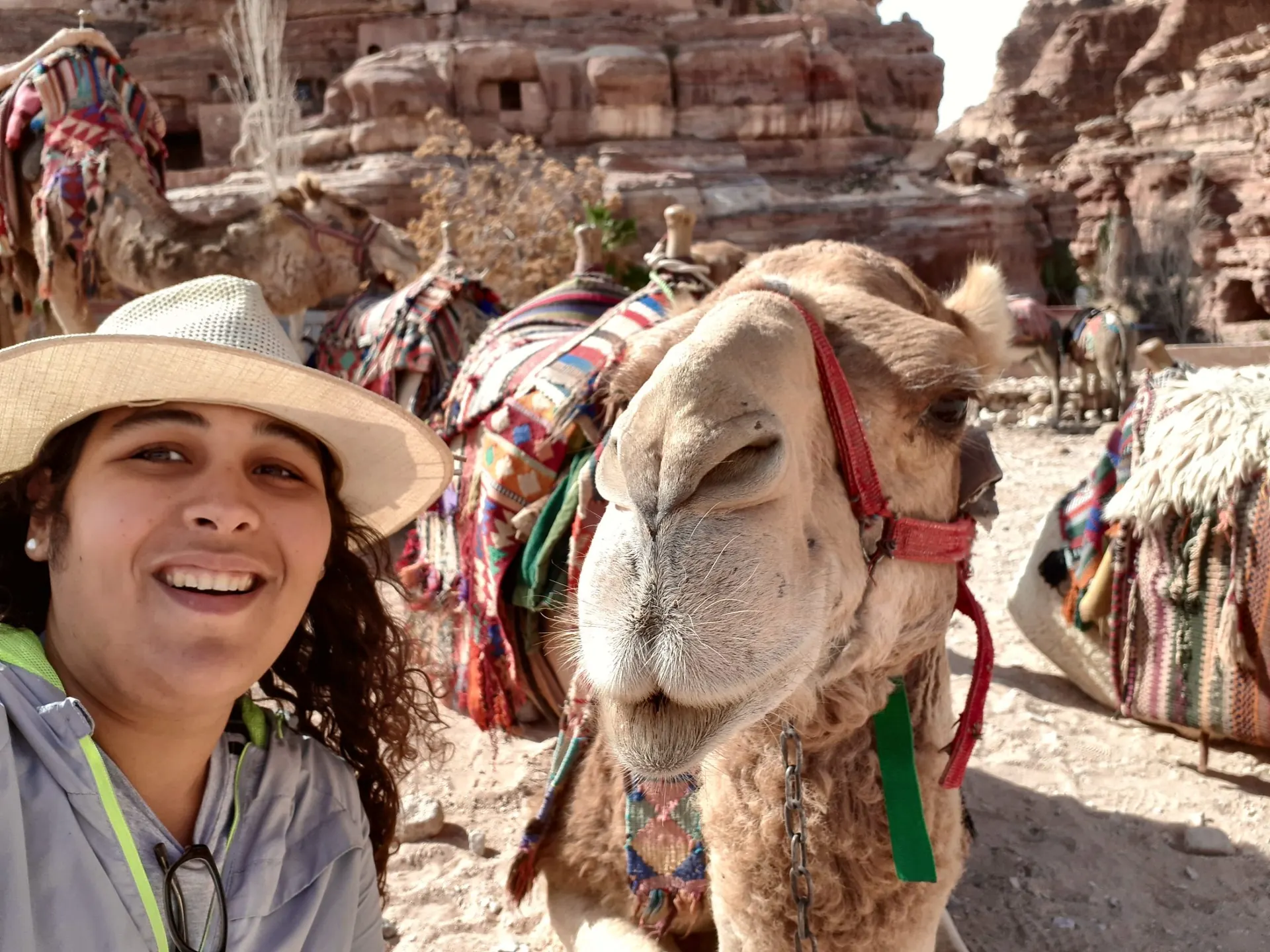 Julia sonriendo junto a un camello en Petra, Jordania